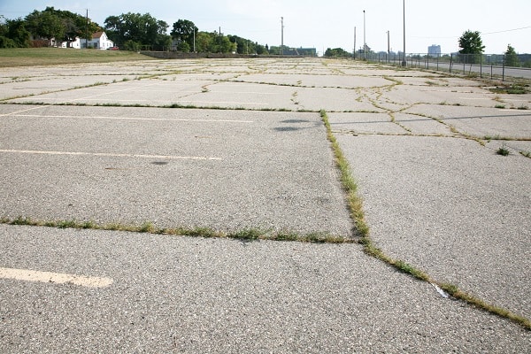 Abandoned employee parking lot - HMA Contracting Featured Image for Top 5 Signs your Parking Lot Needs Maintenance
