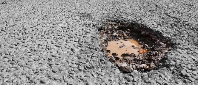 Featured Image for Don’t Let Potholes and Winter Pavement Damage Hurt Your Business